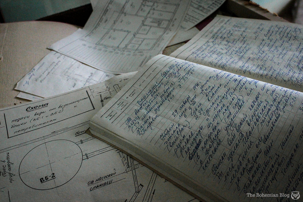 Journals and schematics lie open across a desk in the Chernobyl Radiological Laboratory.
