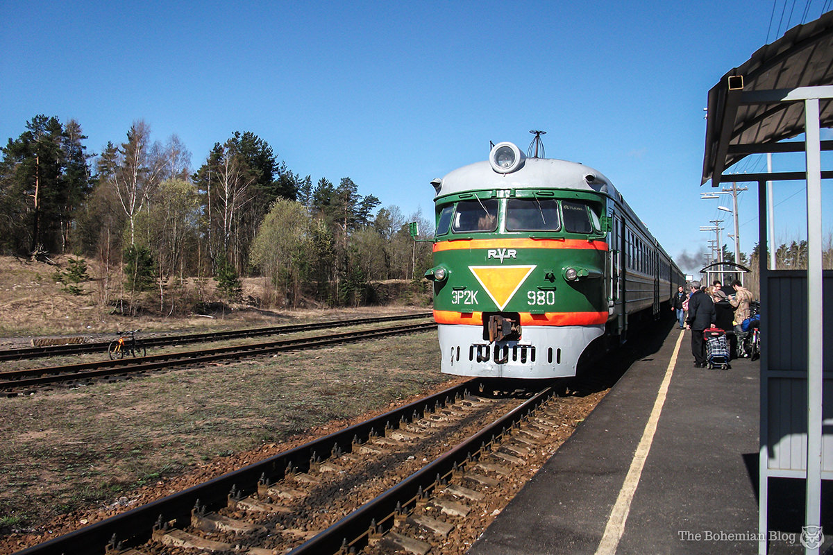 A passenger train pulls into the station, somewhere in rural Russia.