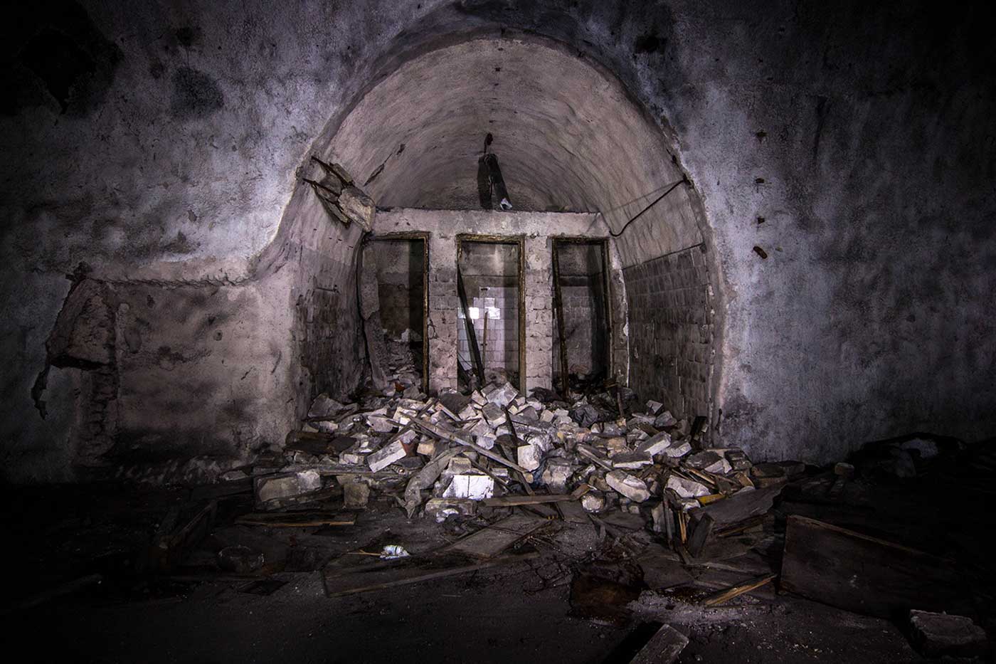 A collapsed toilet block inside the underground complex of Željava Airbase, Yugoslavia.