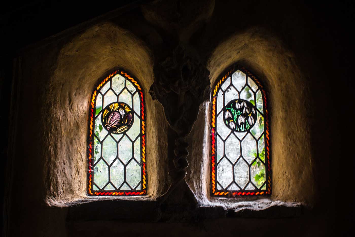 Stained glass windows inside the main building. Colin's Barn, Wiltshire, UK.