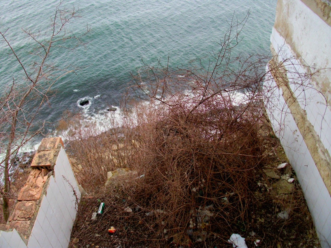 The fallen restaurant: exploring a ruin with a view on the edge of a cliff high above the Bulgarian Black Sea 