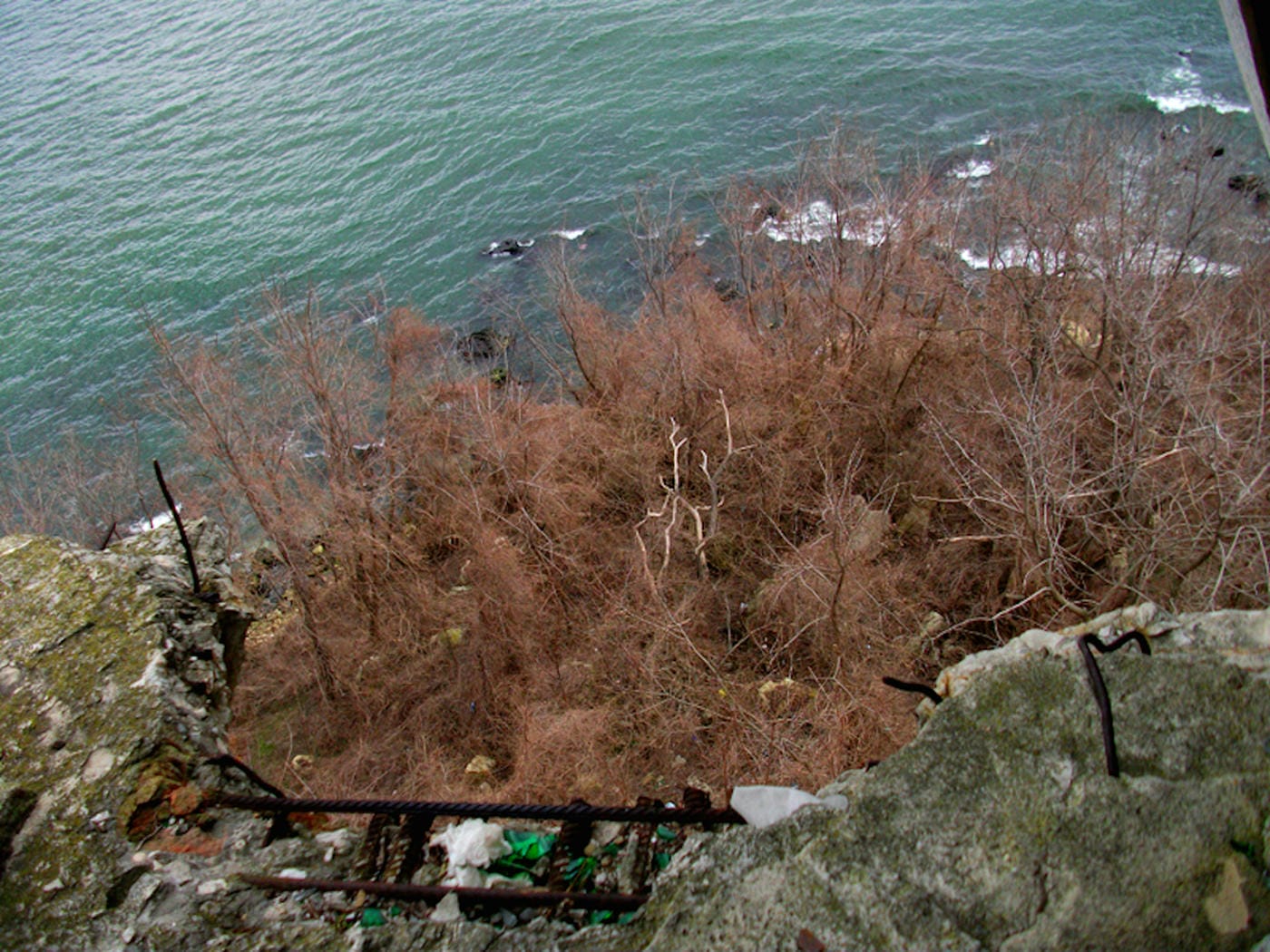 The fallen restaurant: exploring a ruin with a view on the edge of a cliff high above the Bulgarian Black Sea 