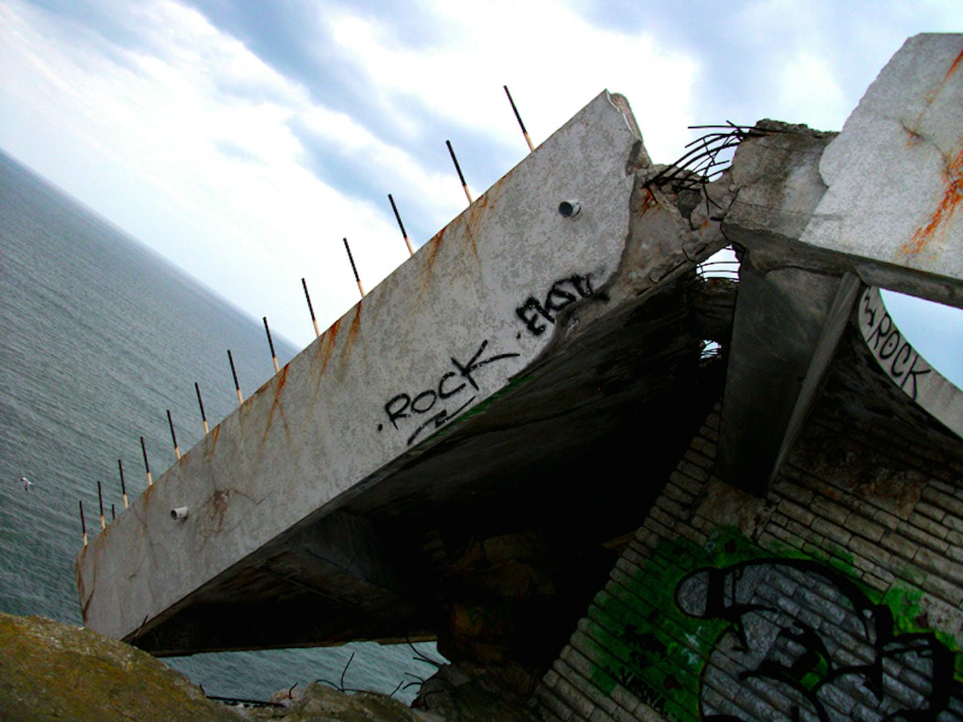 The fallen restaurant: exploring a ruin with a view on the edge of a cliff high above the Bulgarian Black Sea